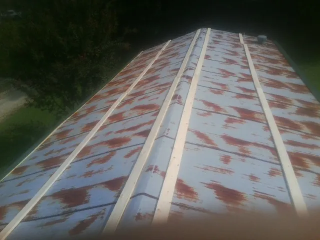 Rusted metal roof panels with new wood purlins before replacement — Storm Damage Roof Repair in Upper Marlboro by Roofing Brothers