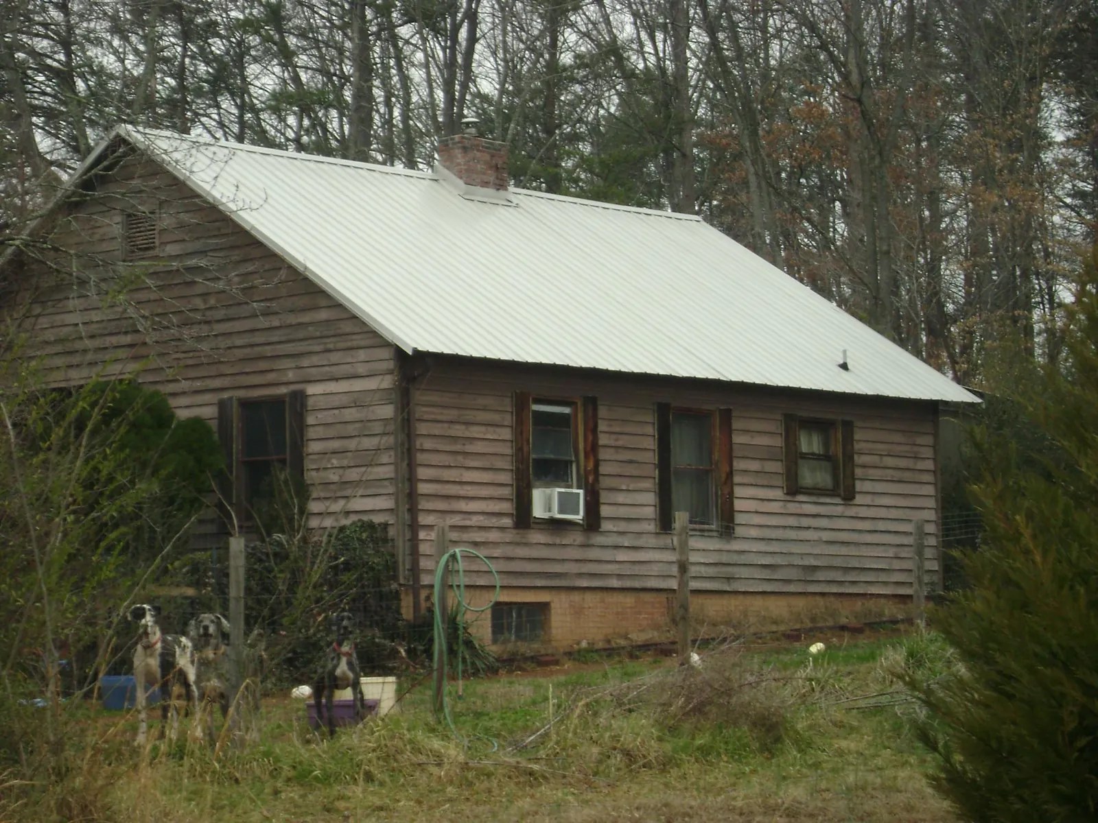 White metal roof on an old wood sided farmhouse, from a Metal Roof Installation job in Upper Marlboro